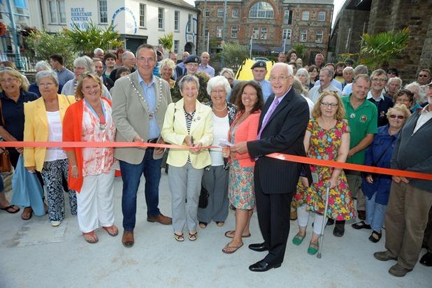 The mayor of Hayle Nick Farrar and president of the Hayle Branch of the RNLI Pauline Marks (centre) watched by members of the community cut the ribbon to officially re-open the Isis gardens in Foundry Square in Hayle The mayor of Hayle Nick Farrar and president of the Hayle Branch of the RNLI Pauline Marks (centre) watched by members of the community cut the ribbon to officially re-open the Isis gardens in Foundry Square in Hayle